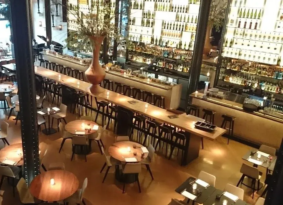 The grand interior of Café Restaurant De Kroon on Rembrandtplein in Amsterdam, with its long bar and dining floor that hosts the free Latin nights