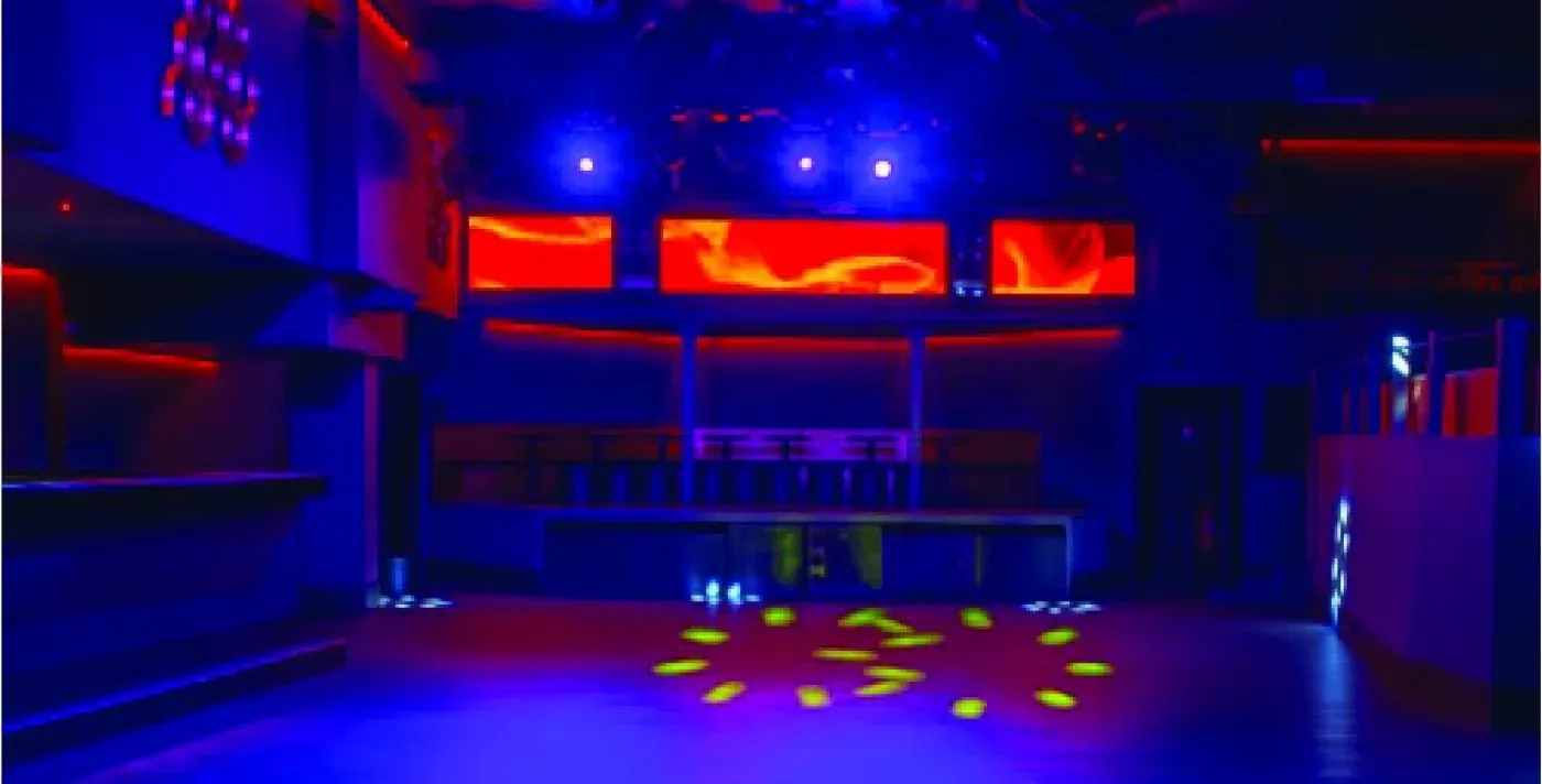 The dance floor at Vendôme Club in the 2nd arrondissement under blue and red club lighting, home of the Tuesday Bachatime social